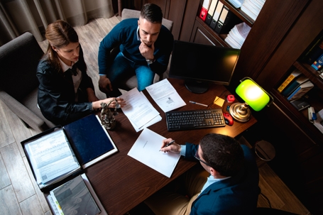 couple reviewing documents with a lawyer
