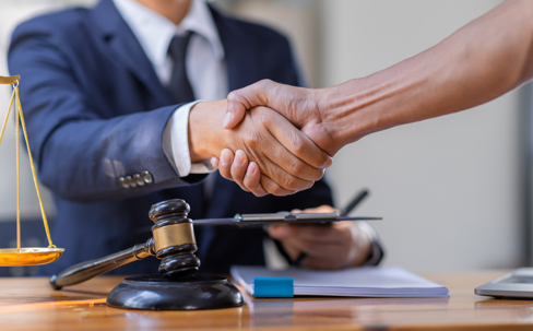 client and lawyer shaking hands